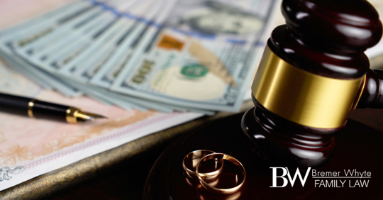 Image of gavel, wedding rings and a pile of money