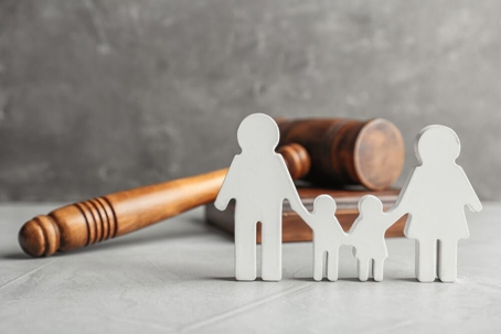 Image of paper-doll family and a judges gavel