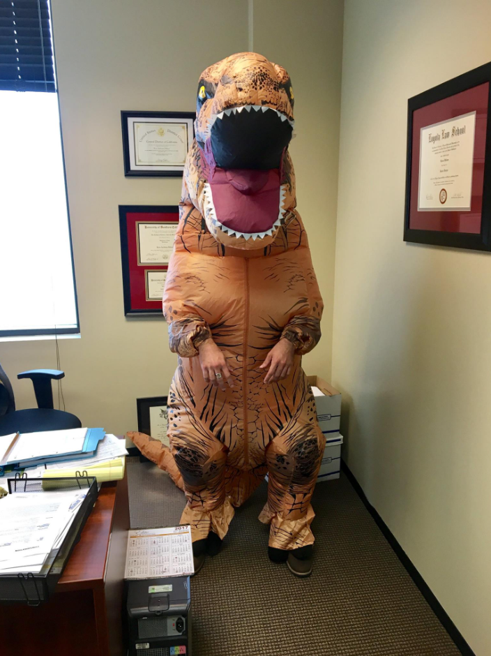 Team member in dinosaur costume