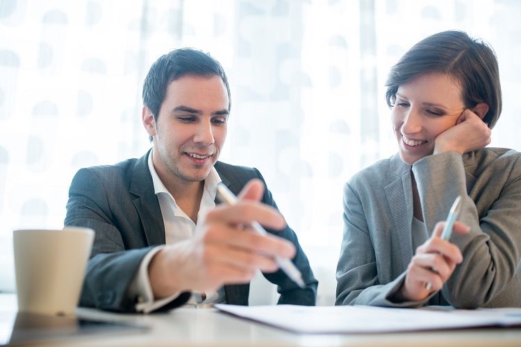 prenuptial and postnuptial agreements A man and woman review documents with a prenup lawyer